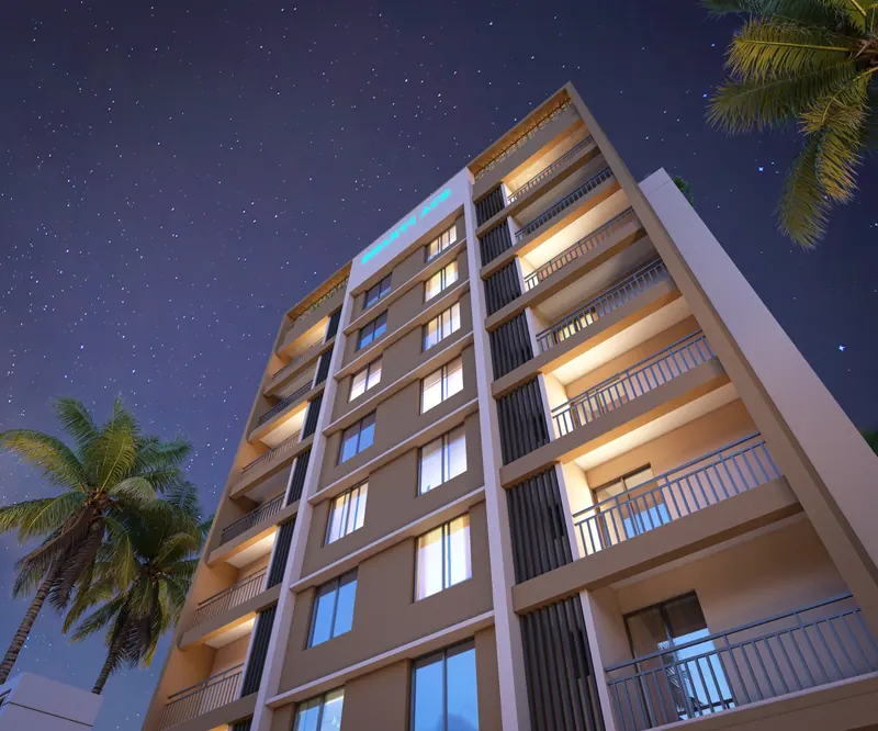 Bhakti ACE façade at night showing the RCC frame and balconies