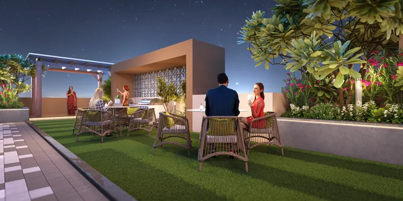 Social rooftop with outdoor sit-outs, landscaped lawn and pergola at night